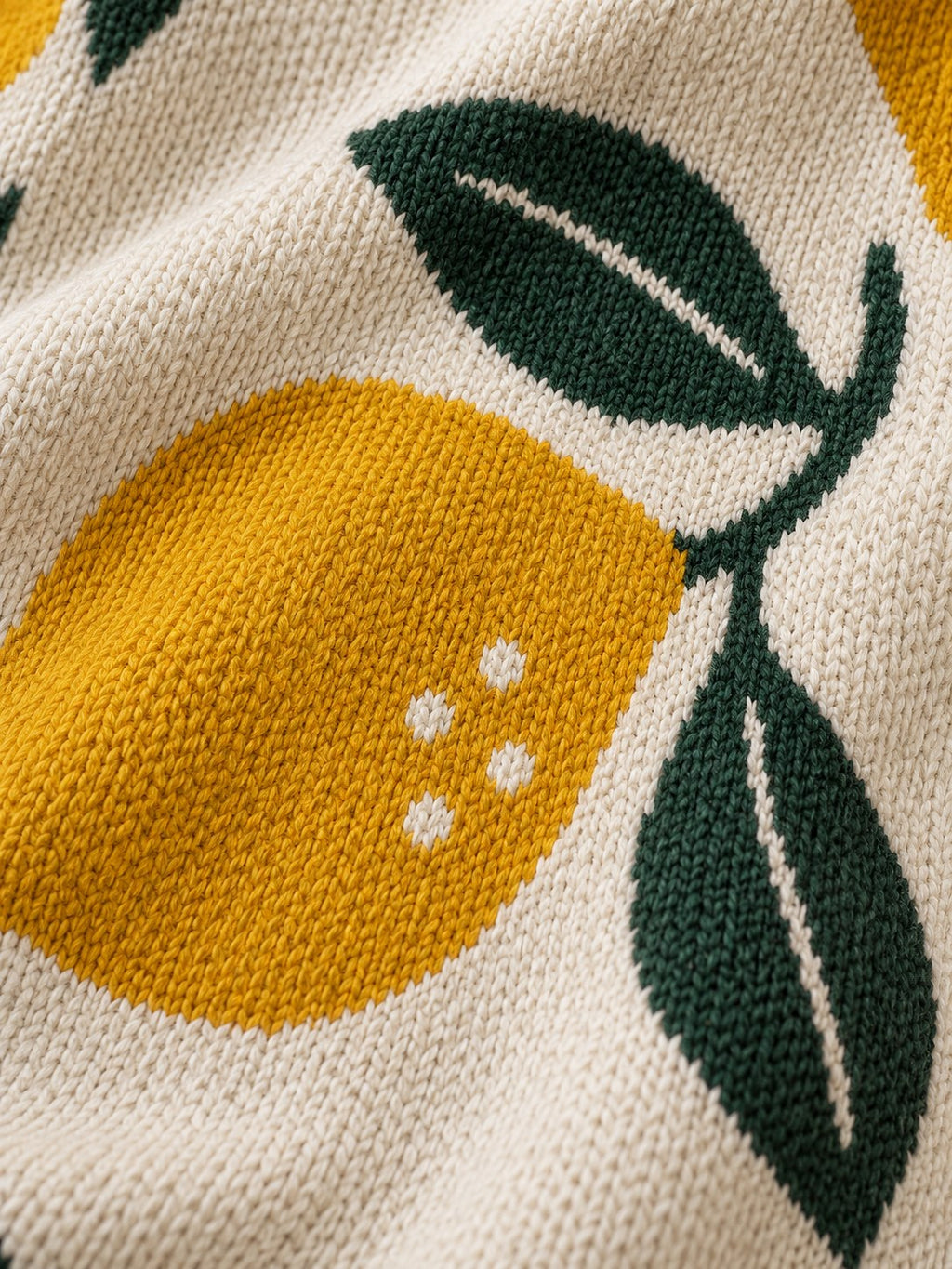 Lemons up close, showing the knit stitches